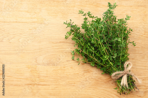 Thyme bunch on wooden background. top view