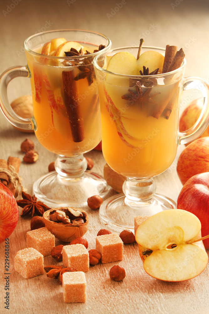 Two cups with hot cider in cold season with cinnamon and anise Two cups with hot cider in cold season with cinnamon and anise