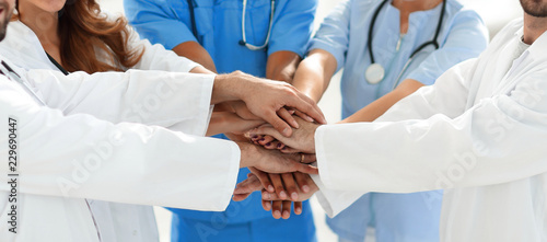 Doctors and nurses stacking hands. concept of mutual aid.
