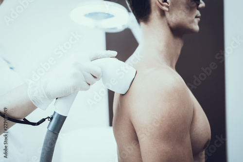 Young Man in Spa Salon for Laser Hair Removal.