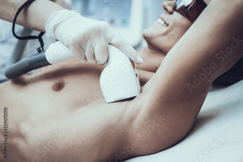 Young Man in Spa Salon for Laser Hair Removal. photo