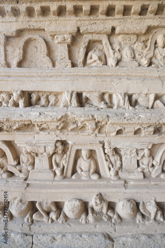 Bas-relief of Buddha and monks on the Stupa at Jaulian monastery, Taxila. photo