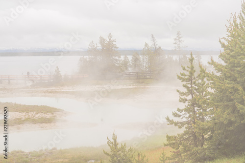 Yellowstone national park landscape. Geothermal activity, hot thermal springs with boiling water and fumes at Yellowstone National Park, USA © Inolas
