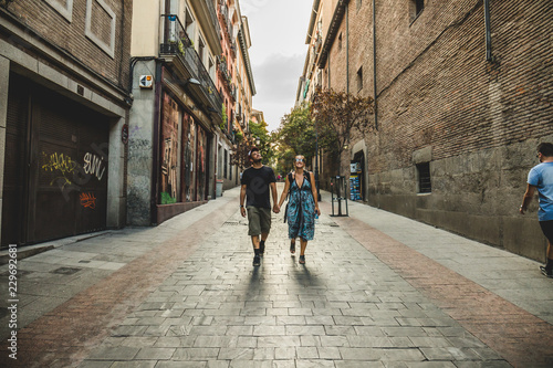 Young couple of tourists walking the streets of Madrid, Spain