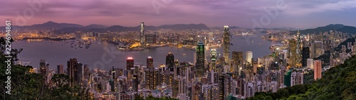Panorama of Hong Kong Skyline at dusk. Night aerial view of skyscrapers. Lights on the ocean
