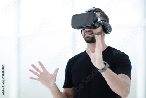 portrait of an amazed guy using a virtual reality headset isolat