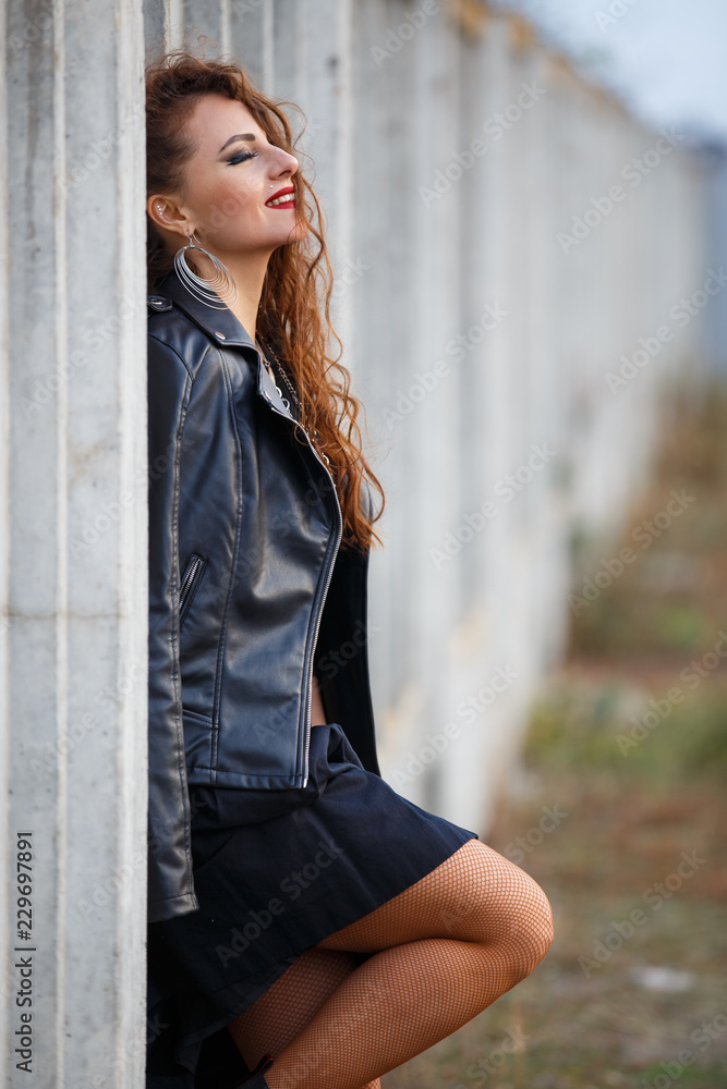 Glam rock style girl in leather jacket Stock Photo | Adobe Stock