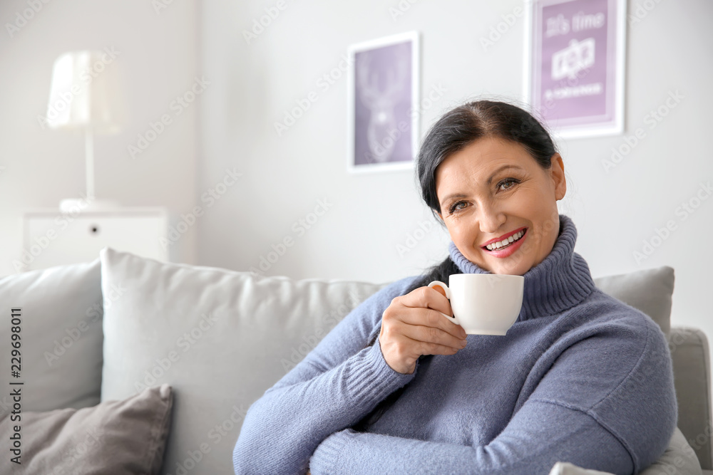 Beautiful mature woman drinking coffee at home Beautiful mature woman drinking coffee at home