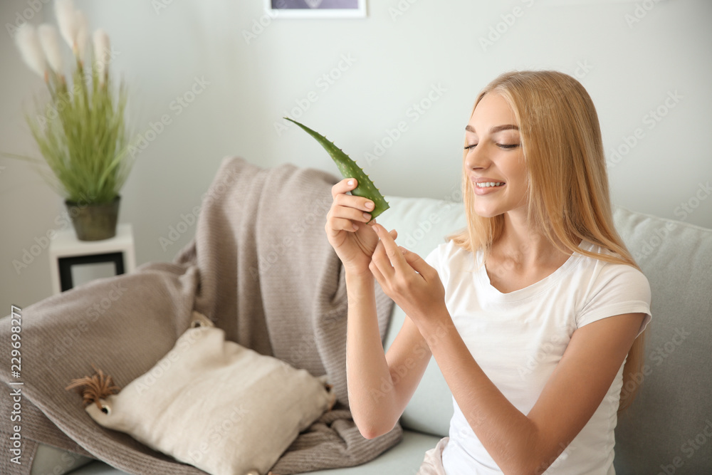 Beautiful young woman using aloe vera at home Beautiful young woman using aloe vera at home