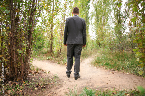 Businessman standing at crossroads. Concept of choice