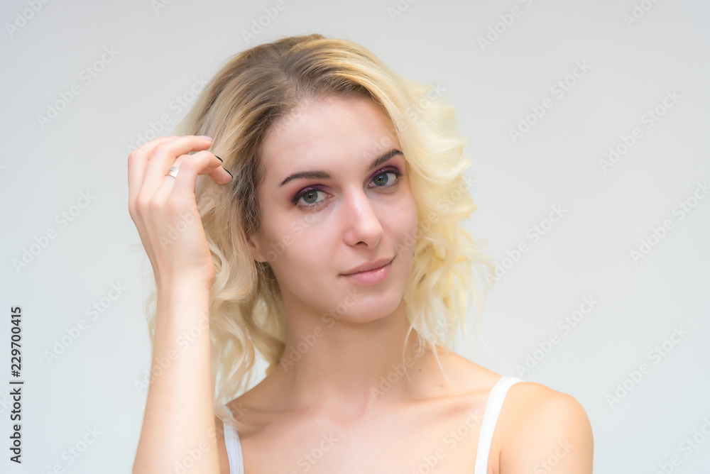 Beauty portrait of a beautiful blonde girl on a white background with perfect makeup. Beauty portrait of a beautiful blonde girl on a white background with perfect makeup.
