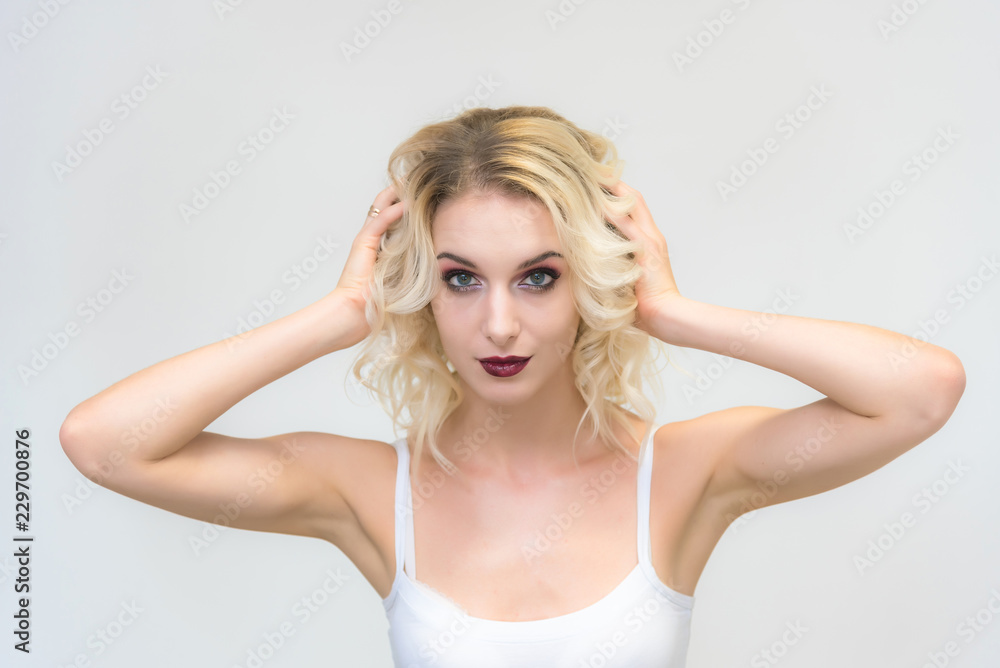 Beauty portrait of a beautiful blonde girl on a white background with perfect makeup. Beauty portrait of a beautiful blonde girl on a white background with perfect makeup.