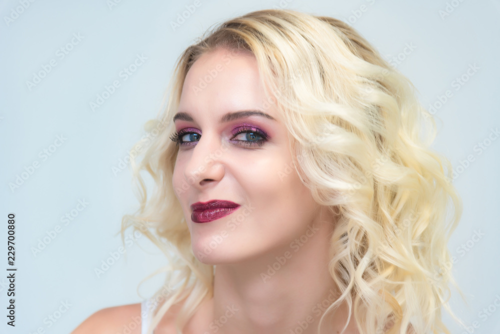 Beauty portrait of a beautiful blonde girl on a white background with perfect makeup. Beauty portrait of a beautiful blonde girl on a white background with perfect makeup.