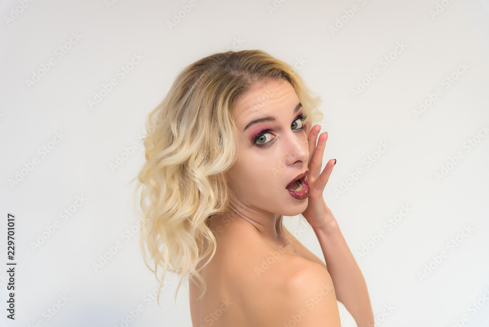 Beauty portrait of a beautiful blonde girl on a white background with perfect makeup. Beauty portrait of a beautiful blonde girl on a white background with perfect makeup.