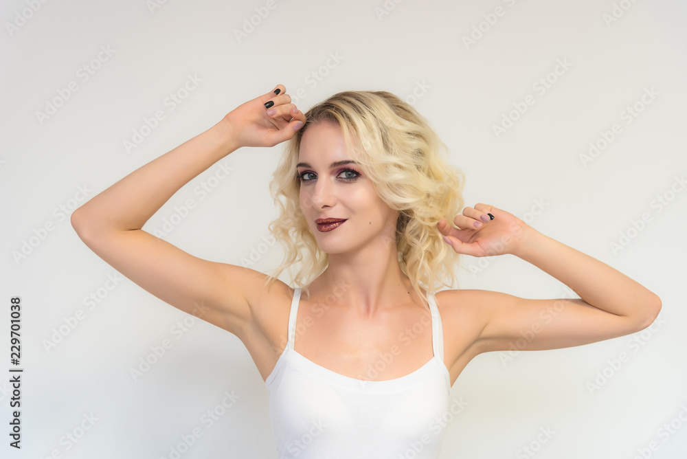Beauty portrait of a beautiful blonde girl on a white background with perfect makeup. Beauty portrait of a beautiful blonde girl on a white background with perfect makeup.