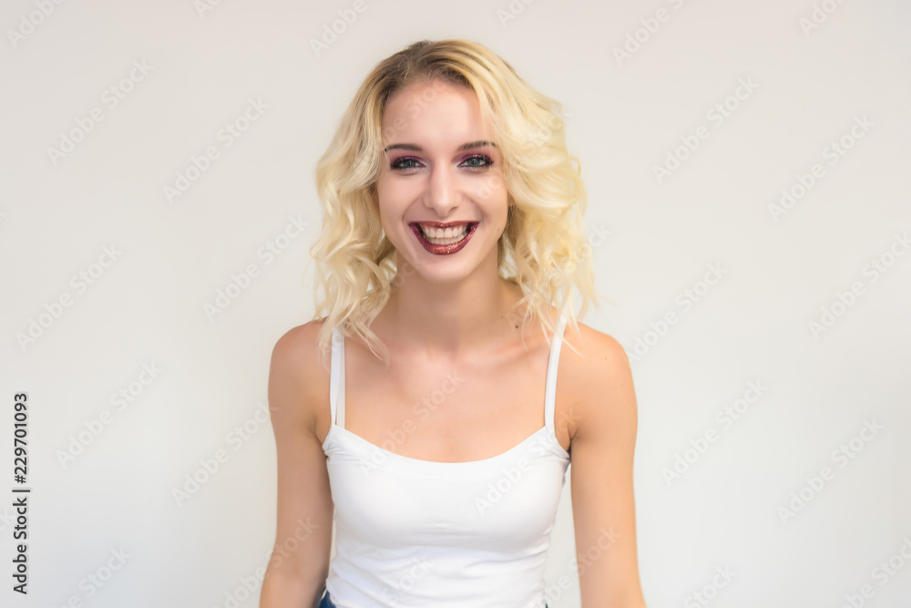 Beauty portrait of a beautiful blonde girl on a white background with perfect makeup. Beauty portrait of a beautiful blonde girl on a white background with perfect makeup.
