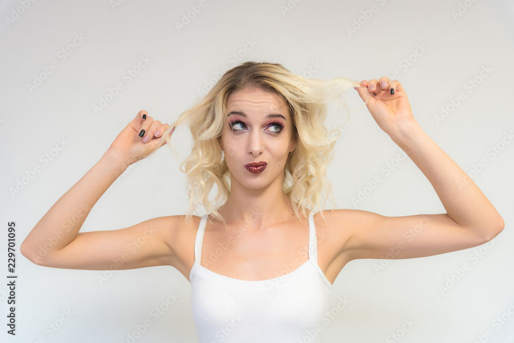 Beauty portrait of a beautiful blonde girl on a white background with perfect makeup. Beauty portrait of a beautiful blonde girl on a white background with perfect makeup.
