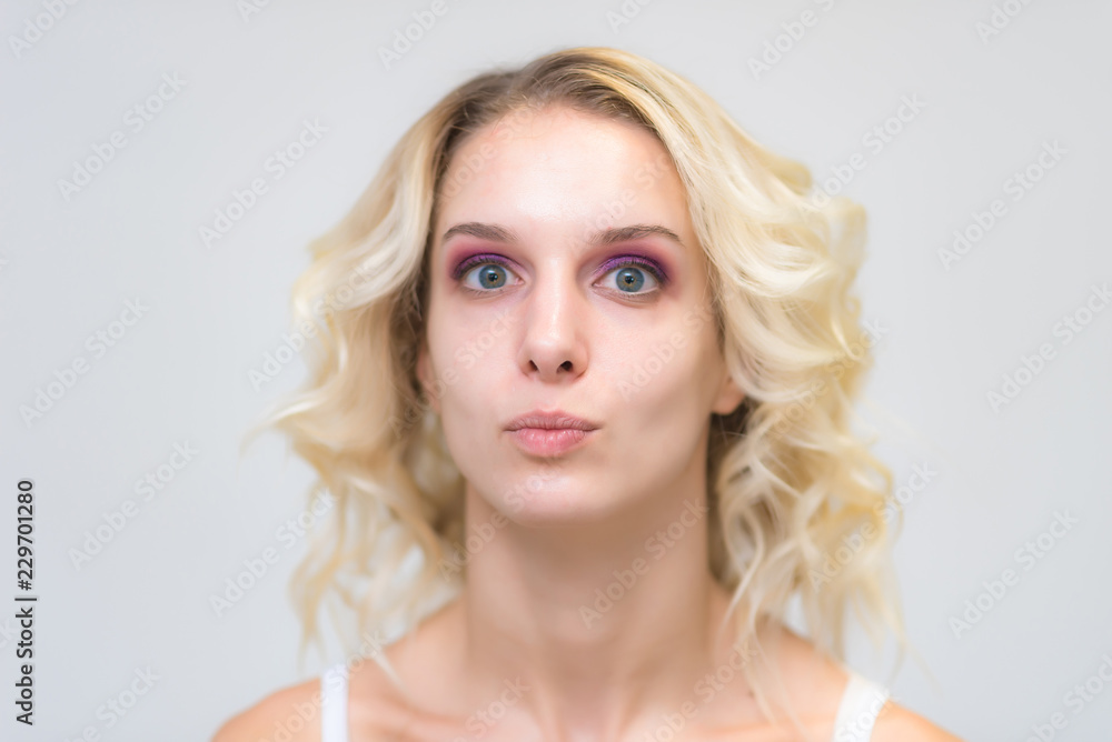 Portrait of a beautiful blonde girl while working as a professional beautician make-up artist. Portrait of a beautiful blonde girl while working as a professional beautician make-up artist.