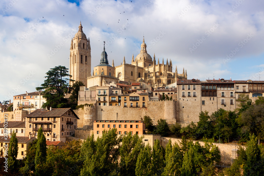 Mirador de Segovia with gothic cathedral, typical old houses, city wall. Trees, pinnacles and tower. Segovia, Spain