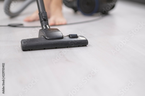 Young Man Cleaning With Vacuum Cleaner At Home