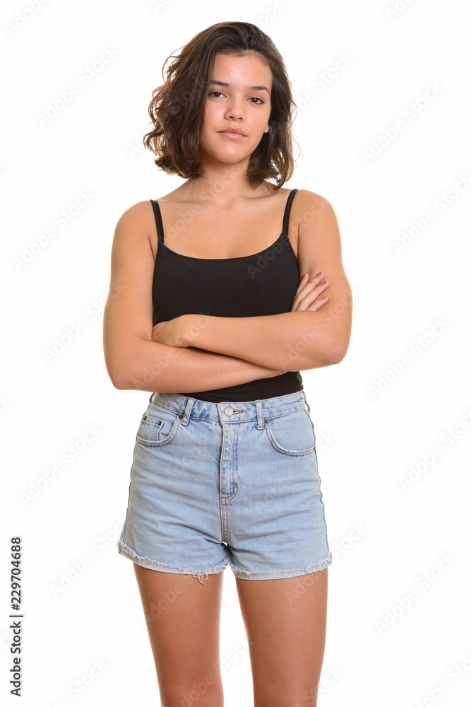 Portrait of young beautiful Caucasian teenage girl with arms crossed Portrait of young beautiful Caucasian teenage girl with arms crossed