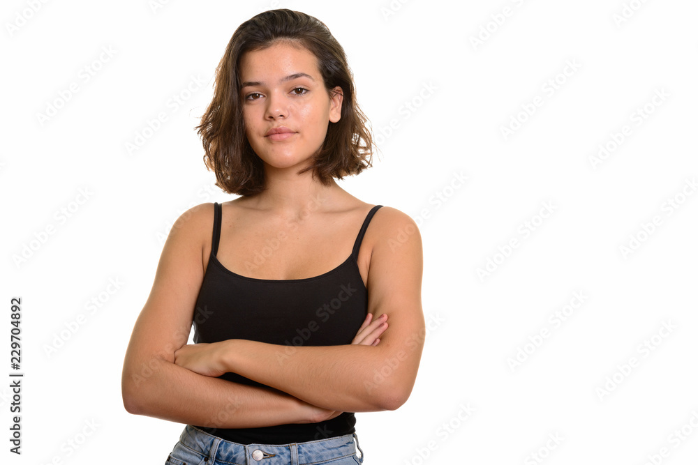 Portrait of young beautiful Caucasian teenage girl with arms crossed Portrait of young beautiful Caucasian teenage girl with arms crossed