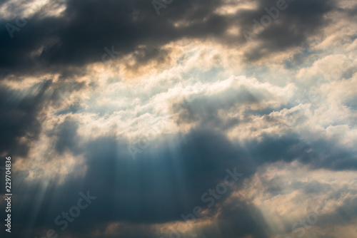 Sun rays through clouds like an dramatic explosion © happystock