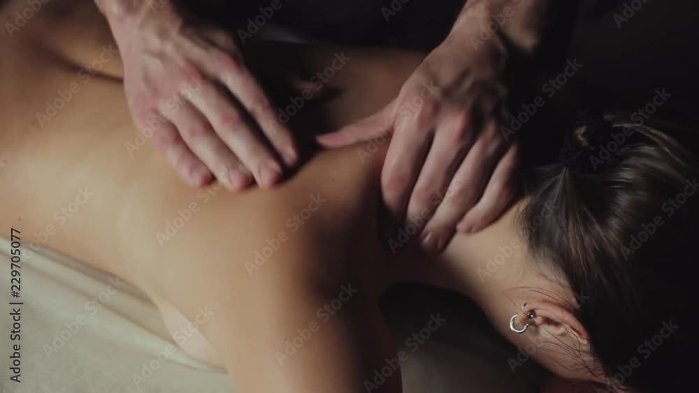 Man therapist doing massage for woman. Man therapist doing massage for woman.