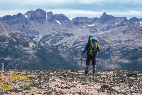 One man backpacker stands in front of mountains of Patagonia