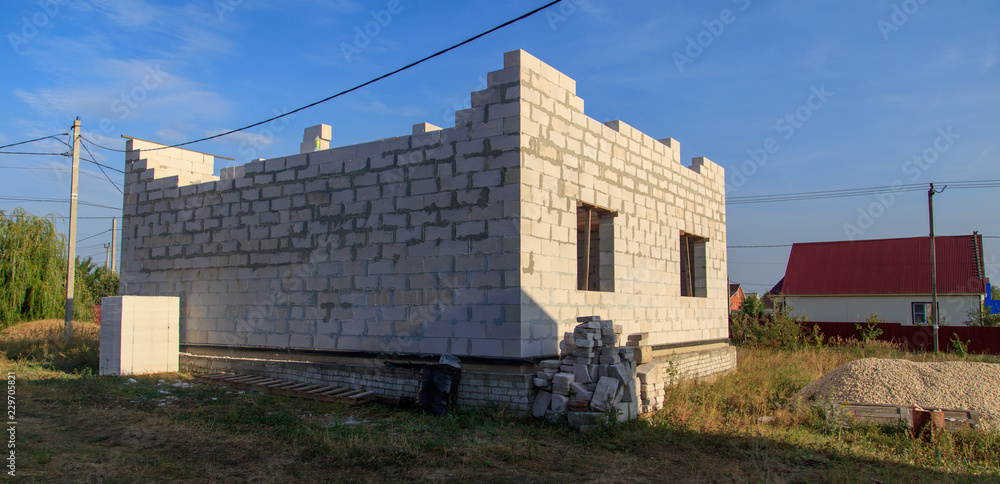 Fototapeta premium Brick house under construction in the village
