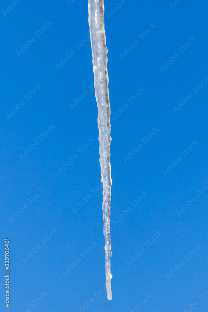 Icicles against the blue sky in winter Icicles against the blue sky in winter