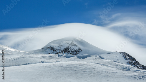 White winter mountains covered with snow in blue cloudy sky. Alps. Austria. Pitztaler Gletscher © Evgeniya Biriukova