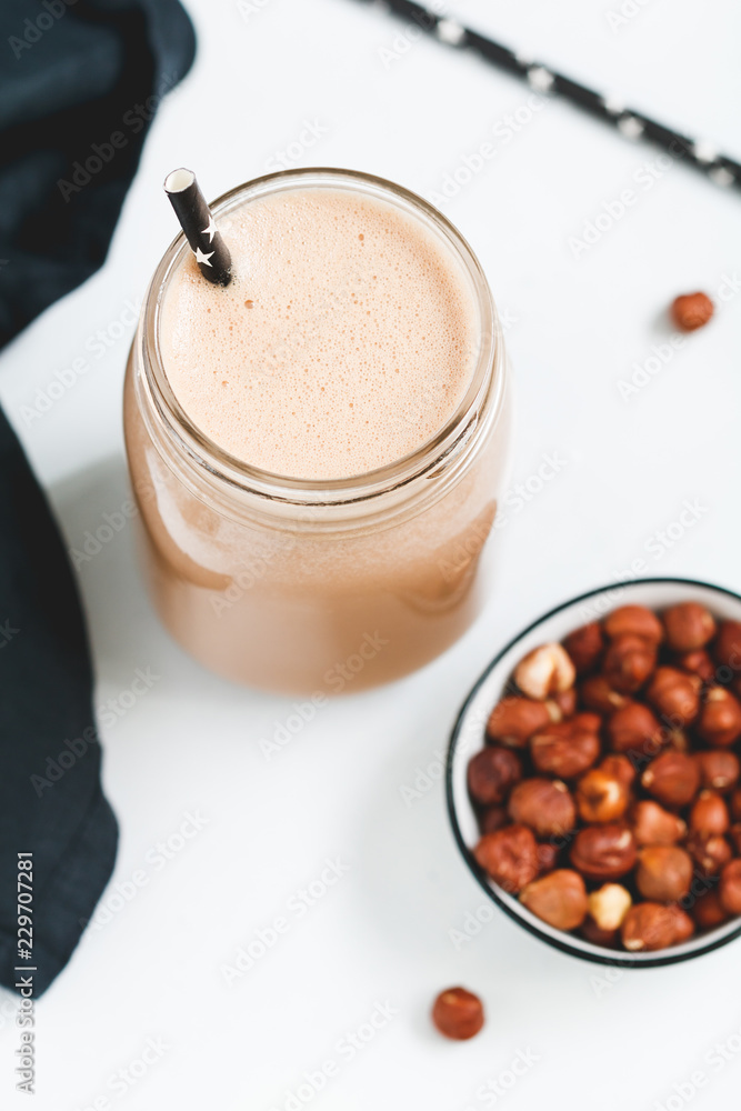 Nut butter chocolate protein shake in a glass jar. The concept of a healthy lifestyle and fitness diet. Nut butter chocolate protein shake in a glass jar. The concept of a healthy lifestyle and fitness diet.