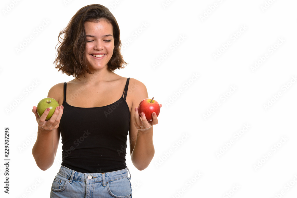 Young happy Caucasian teenage girl smiling while choosing betwee Young happy Caucasian teenage girl smiling while choosing betwee