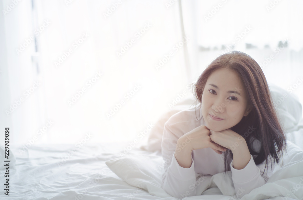 Beautiful woman sleeping in the bedroom. Asian women sleep well.Sleeping in a white room makes you feel comfortable. Warm tone. Beautiful woman sleeping in the bedroom. Asian women sleep well.Sleeping in a white room makes you feel comfortable. Warm tone.