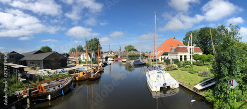 Panorama from a canal with wooden sailboats photo