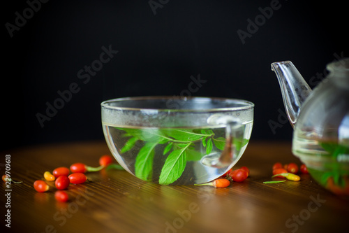 hot tea from ripe red goji berries in a glass teapot