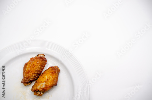 Close up.Fried chicken wings in a white plate.