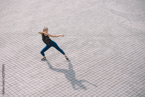 high angle view of young woman performing contemporary dance on street