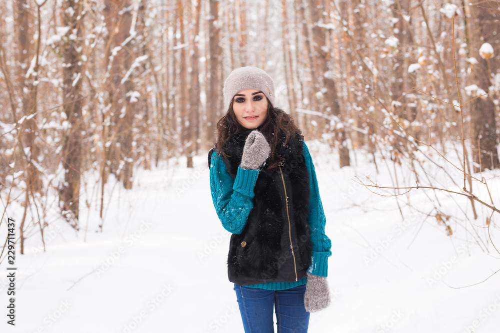 Beautiful young woman walking in the winter snowy nature Beautiful young woman walking in the winter snowy nature