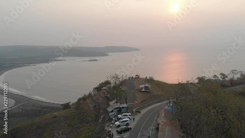 Aerial view clip of Puncak Darma at sunset, overlooking Geopark Ciletuh coastline in Sukabumi, Indonesia. photo