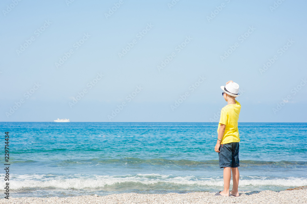 Little boy enjoying on the beach. Empty space for text Little boy enjoying on the beach. Empty space for text