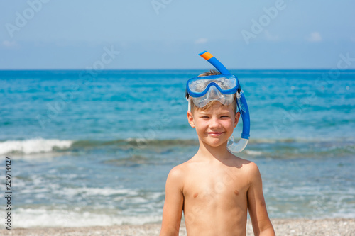 Happy boy in snorkelling mask at beach. Empty space for text