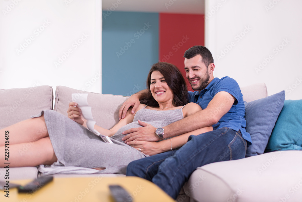 pregnant couple looking baby's ultrasound pregnant couple looking baby's ultrasound