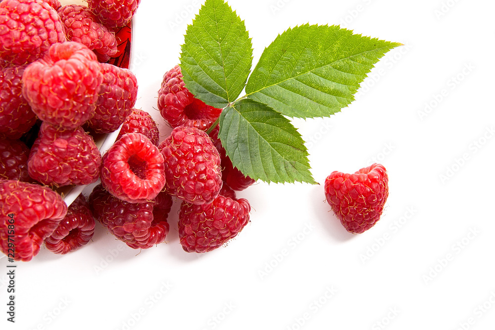 Small plate with ripe raspberries and green leaf isolated on white background. Small plate with ripe raspberries and green leaf isolated on white background.