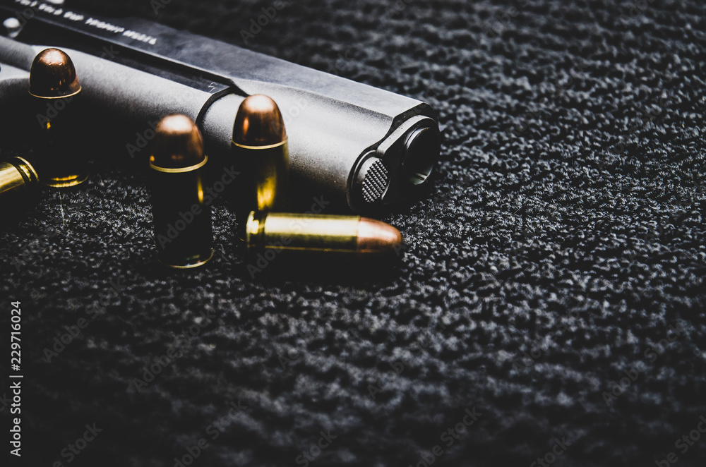 Guns and ammunition are placed on a black background.Monochrome tone.Do not focus on objects