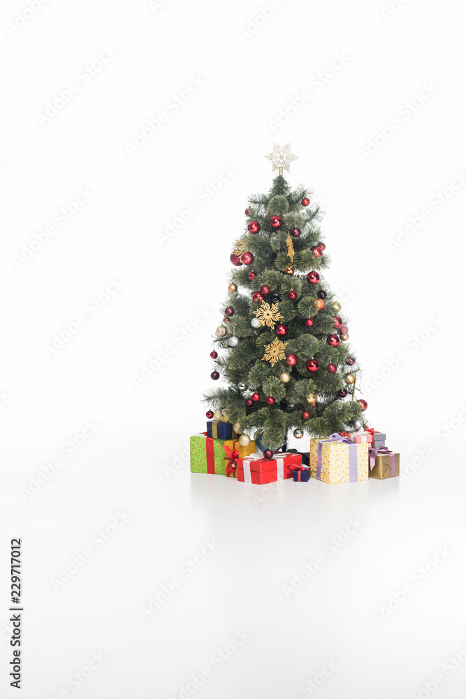 close up view of festive christmas tree and wrapped gifts isolated on white close up view of festive christmas tree and wrapped gifts isolated on white