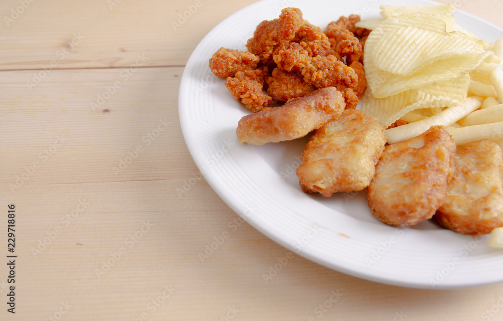 Crisps Fried food in white plate The waistline is on the table.Healthy eating and active lifestyle concept.Do not focus on objects. Crisps Fried food in white plate The waistline is on the table.Healthy eating and active lifestyle concept.Do not focus on objects.