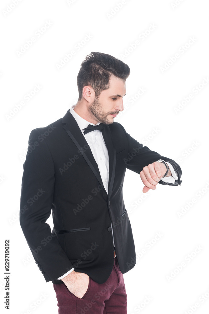 young man in fashionable suit checking time isolated on white young man in fashionable suit checking time isolated on white