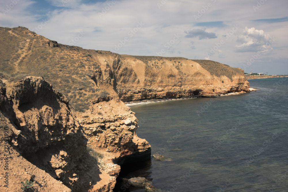 Obraz premium Sea and steep rugged cliffs. Coast of Crimea. Travel Lifestyle concept outdoor.